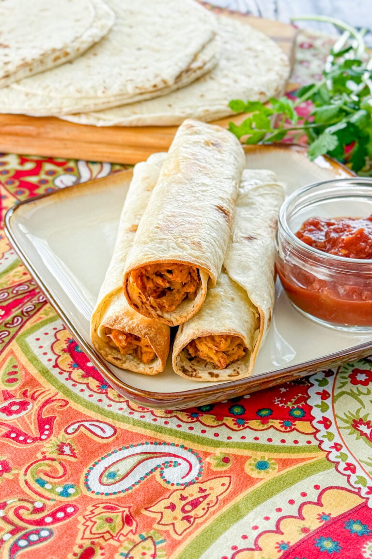 Slow cooker baked chicken taquitos served with dipping salsa