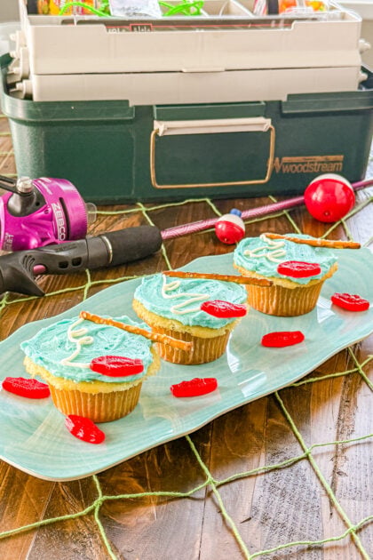 Fishing themed cupcake topped with a mini Swedish Fish and pretzel stick pole