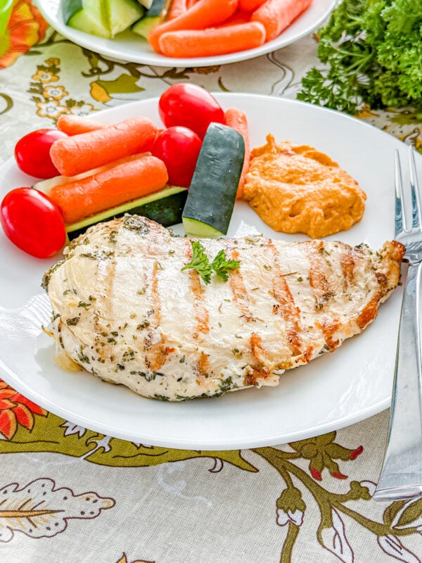 Grilled Italian marinated chicken breasts on a plate