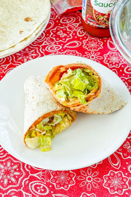 Close-up of a pizza salad wrap with romaine, pizza sauce, and pepperoni