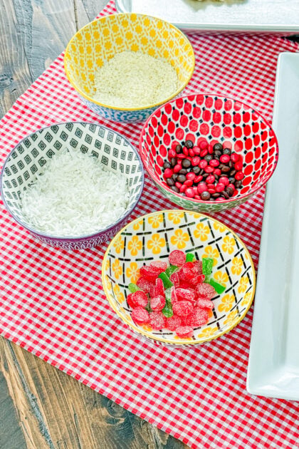 Coconut, white chocolate, DOTS, and mini M&M’s for decorating Pizza sugar cookies