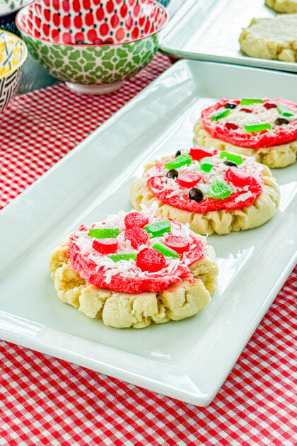 Pizza sugar cookies decorated with red frosting, candy toppings, and sweet cheese