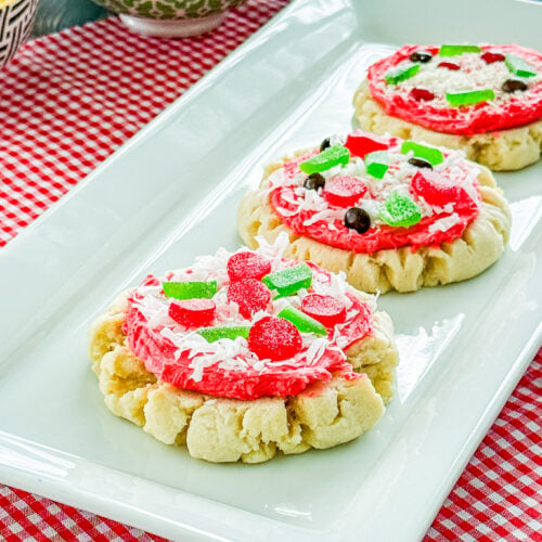 Pizza sugar cookies decorated with red frosting, candy toppings, and sweet cheese