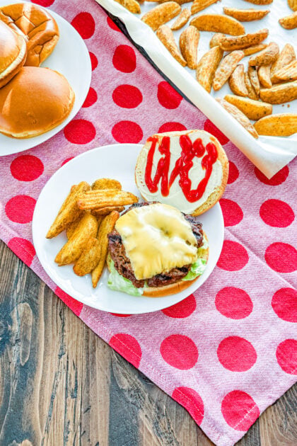 Overhead view of glazed cola burger served with fresh toppings on a hamburger bun