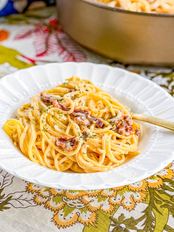 Creamy sun-dried tomato pasta served with basil and Parmesan cheese