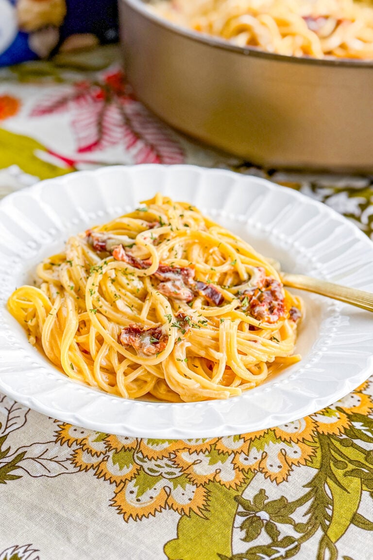 Creamy sun-dried tomato pasta served with basil and Parmesan cheese