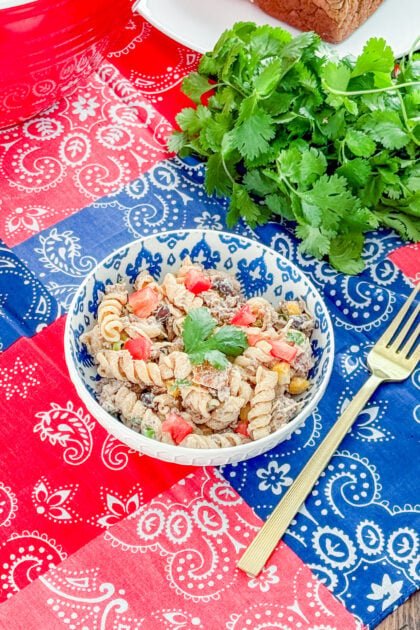 Healthy cowboy pasta salad with protein pasta, ground beef, bacon, black beans, corn, and tomatoes