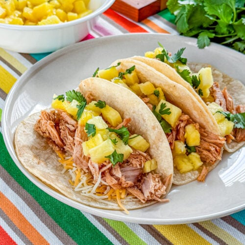 Close-up of tacos al pastor with tender shredded pork and fresh pineapple
