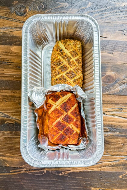Cream cheese scored in a crosshatch pattern and seasoned in a foil pan after smoking