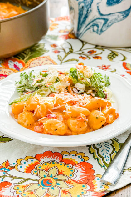Close-up of creamy tomato gnocchi coated in tomato sauce and topped with Parmesan
