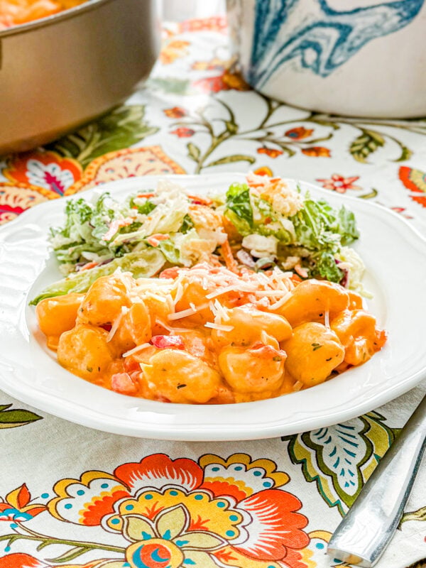 Close-up of creamy tomato gnocchi coated in tomato sauce and topped with Parmesan