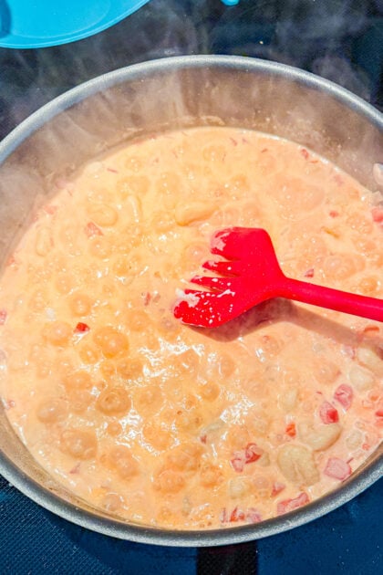Creamy tomato gnocchi in a skillet with a rich tomato cream sauce and Parmesan cheese