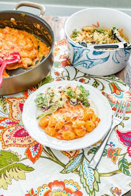 Plate of creamy tomato gnocchi garnished with Parmesan cheese
