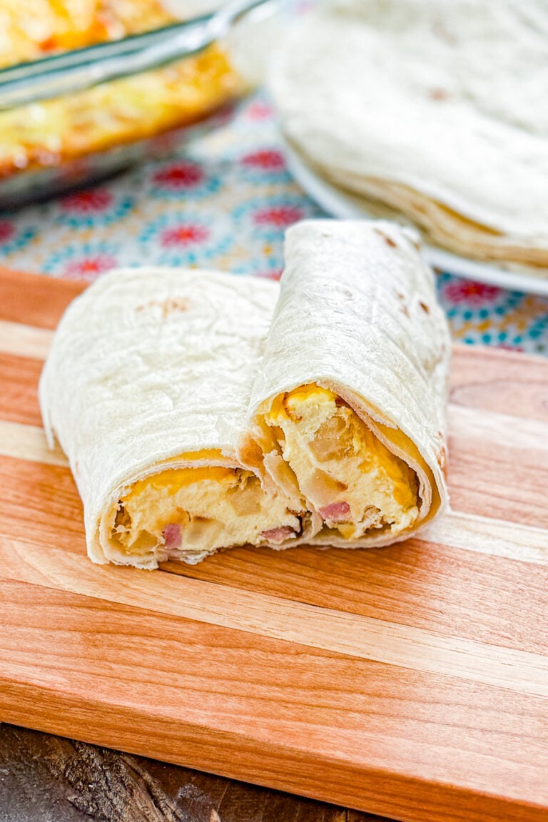 Easy baked ham and hash brown breakfast burritos filled with eggs, cheese, ham, and potatoes
