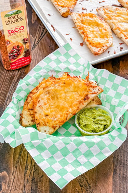 Overhead view of baked chicken quesadillas served with guacamole