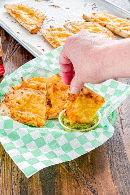 Baked chicken quesadilla cut into wedges with cheesy chicken filling