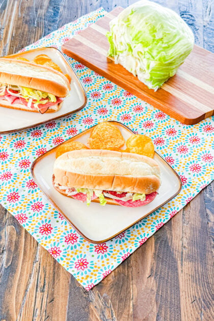 Italian sub topped with lettuce, provolone cheese, and Italian seasoning on a toasted roll