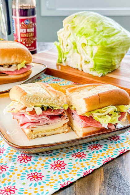 Easy Italian sub sandwich with deli meats, provolone cheese, lettuce, and Italian seasoning