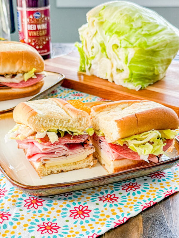 Easy Italian sub sandwich with deli meats, provolone cheese, lettuce, and Italian seasoning