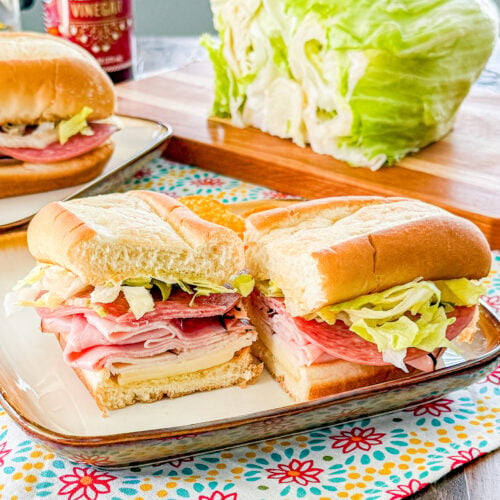 Sub roll layered with Italian deli meats, provolone cheese, and lettuce