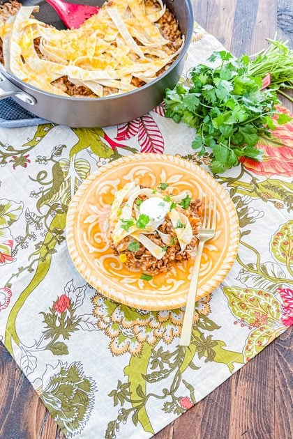 Beef enchilada rice skillet topped with sour cream and fresh cilantro