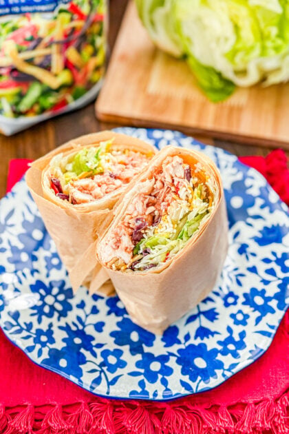 Close-up of a sliced Whiskey River chicken wrap with barbecue chicken and crispy tortilla strips