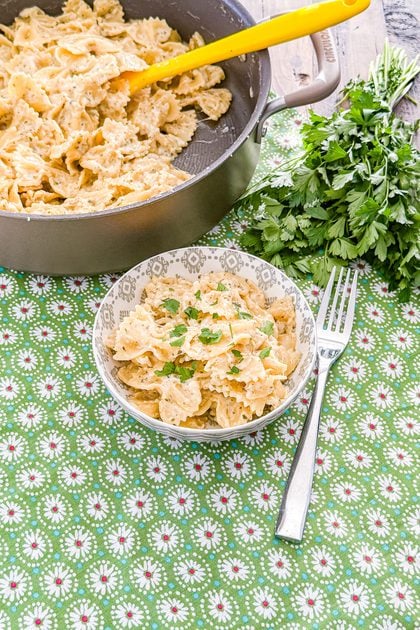 Garlic butter pasta served in a bowl with Parmesan cheese and herbs