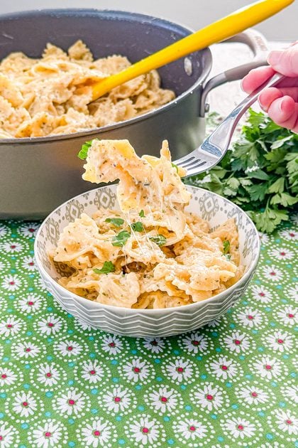 Forkful of creamy garlic butter pasta coated in Parmesan sauce