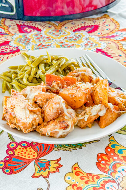 Slow Cooker Garlic Parmesan Chicken and Potatoes with melted mozzarella cheese