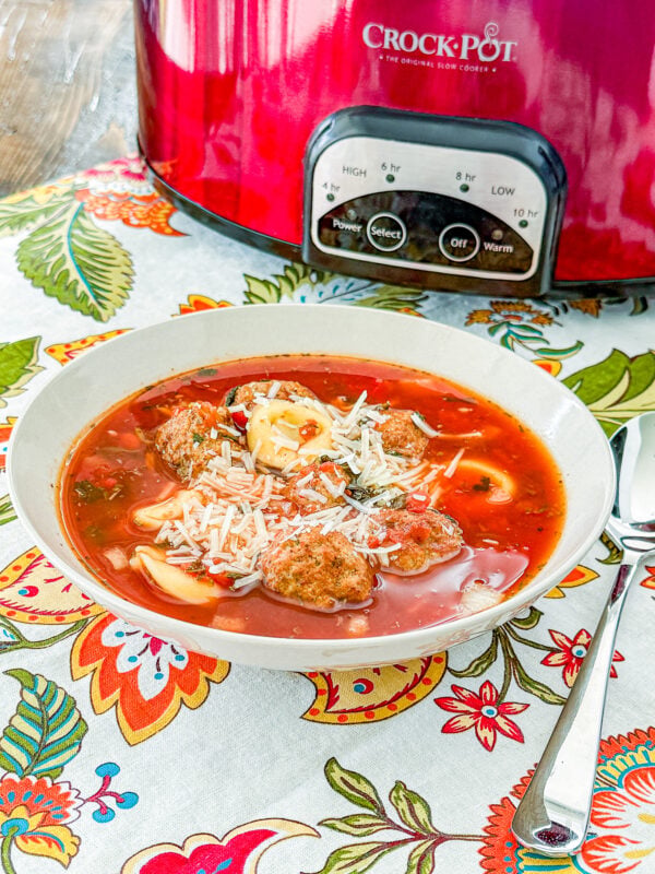 low Cooker Meatball Tortellini Soup with Italian meatballs, cheese tortellini, tomatoes, spinach, and Parmesan