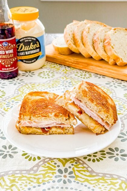Sourdough turkey bacon melt cut in half showing turkey, bacon, cheese, and tomato