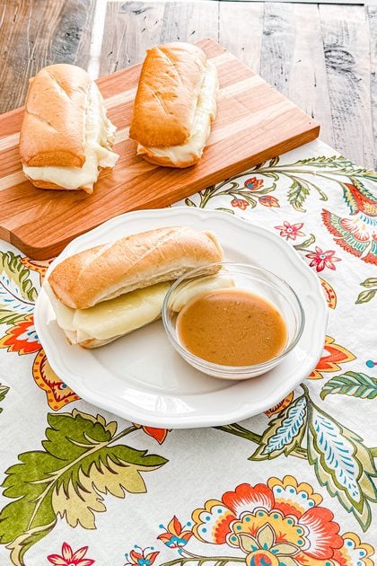 Turkey French dip sandwich served with a bowl of savory herb gravy