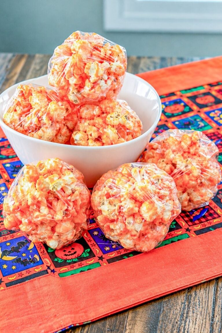 Classic popcorn balls with a sweet marshmallow coating and orange Halloween coloring