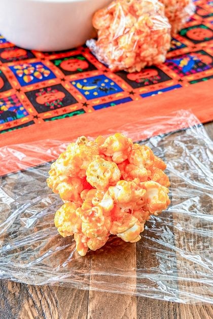 Close-up of a soft and chewy classic popcorn ball with a sweet candy coating ready to be wrapped
