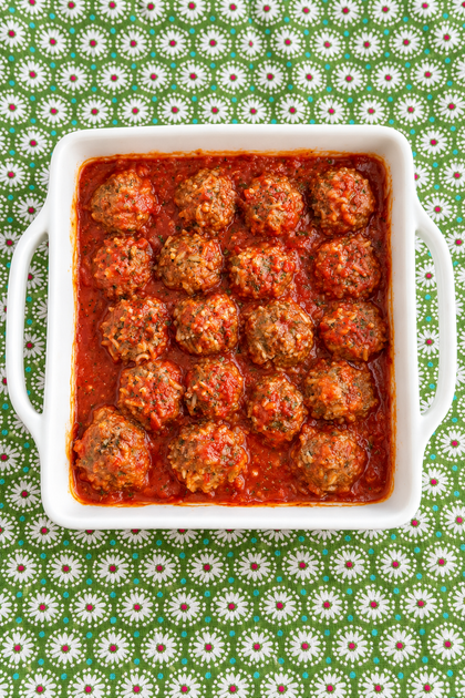 Easy Baked Porcupine Meatballs with rice in tomato sauce in a white casserole dish