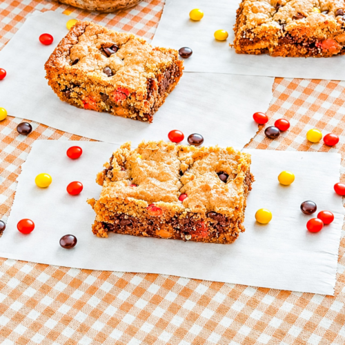 Close-up of soft and chewy peanut butter blondies with Reese’s Pieces