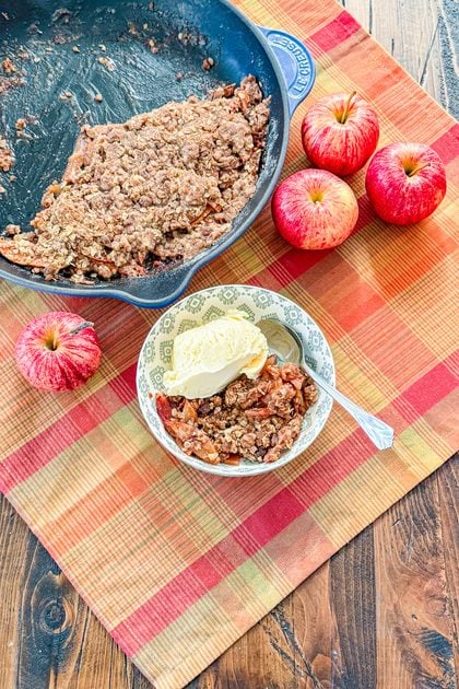 Smoked apple crisp with cinnamon apples, buttery oat topping, and vanilla ice cream